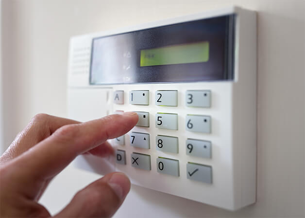 person using home security system panel