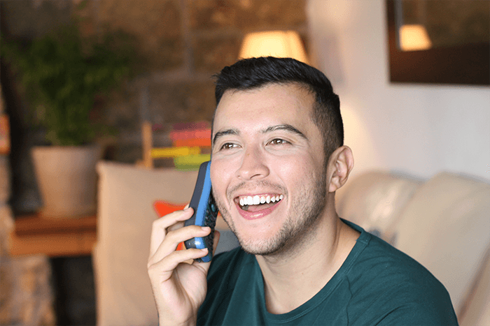 man on happily using telephone